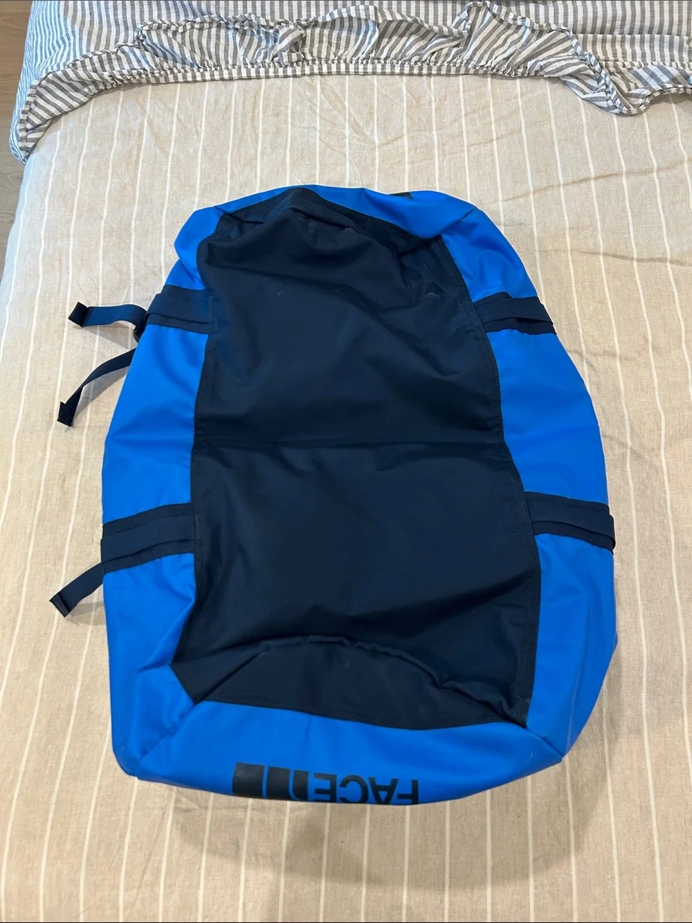 The North Face Blue Duffel Bag with Navy Logo and Straps